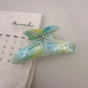 Exquisite rhinestone starfish resin hair claw clip, elegant blue and yellow marble design.