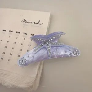 Purple resin starfish hair claw clip with rhinestones, elegant big shark clip detail view.