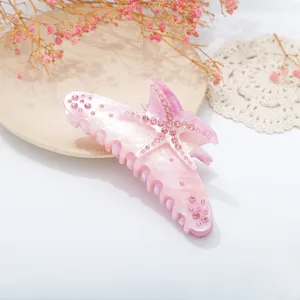 Pink resin starfish hair claw clip with sparkling rhinestones for women, elegant shark clip.