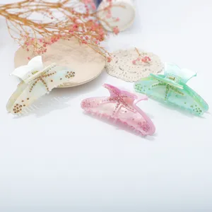 Detailed view of rhinestone starfish hair claw clips in multi-colors, elegant resin shark clip.