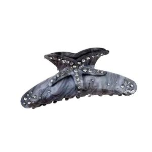 Detailed view of grey resin hair claw clip with starfish shape and sparkling rhinestones.