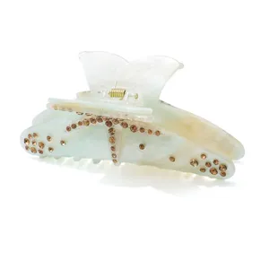 Elegant resin hair claw clip with sparkling rhinestones and starfish design for women and girls.