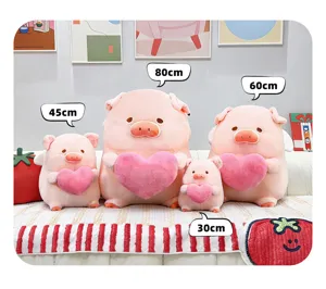 Simpatico maialino di peluche rosa con cuore, vista di dettaglio mostra varie taglie disponibili.
