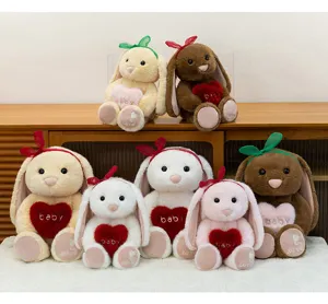 Cute long-eared bunny plush toy holding a heart pillow, soft and comforting stuffed doll.