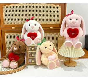 Cute long-eared bunny plush toy holding a heart pillow, soft comforting doll gift for girls.