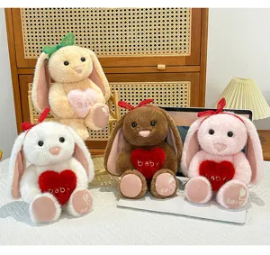 Cute plush bunny toy holding soft heart pillow, premium stuffed animal gift with sweet details.