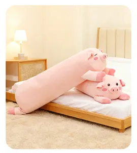 Close-up detail of cute pink plush pig long pillow, soft sleeping companion toy for cozy bed.