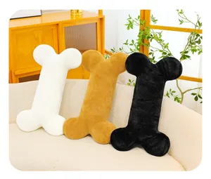 Cozy bone shaped plush throw pillow detail, soft textured decorative cushion for sofa bed.