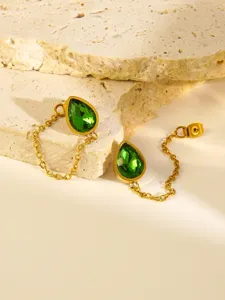 Detailed close-up of teardrop green crystal chain earrings in 18K gold plated stainless steel.