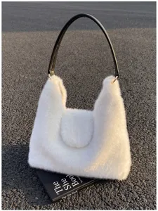 Detailed view of white plush shoulder tote bag with black leather handle, fluffy winter style.