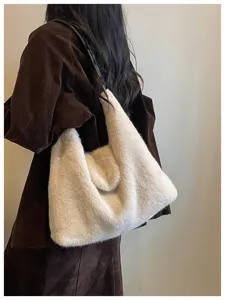 Close-up of fluffy plush shoulder bag, cozy cream furry tote for daily winter wear.
