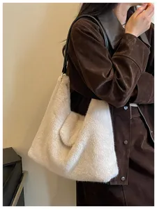 Fluffy plush shoulder bag detail showing the soft cream-white faux fur texture and black strap.