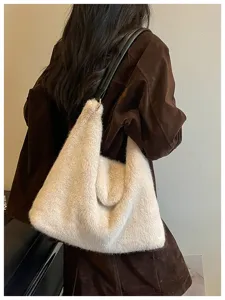 Cozy faux fur shoulder bag detail, soft plush texture and sleek black leather strap design.