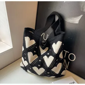Knit shoulder bag with black and white heart pattern, stylish casual tote bag for women.