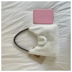 Fluffy faux fur shoulder bag for women, cozy winter fuzzy tote bag with black strap.