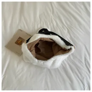 Detailed view of the plush shoulder bag interior, showing soft texture and spacious brown lining.
