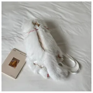 Detail shot of the white plush cat backpack showing soft fur texture and zipper design.