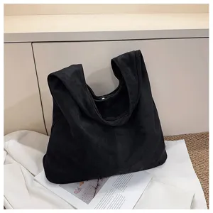Black slouchy shoulder tote bag detail, soft minimalist design for daily commuter use.