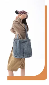 Detail view of the large capacity washed denim tote bag showing its durable casual fabric.