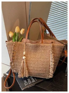 Woven straw shoulder bag detail, stylish fringe tassel decor, casual beach tote design.