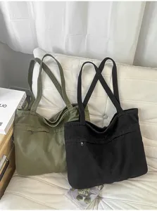Vista di dettaglio della borsa tote in tela casual con tasca frontale, nero e verde.