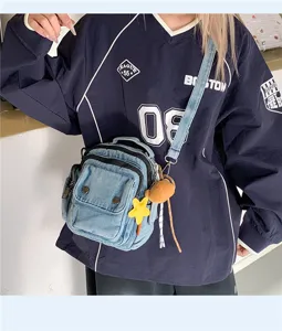 Detailed view of the women casual denim crossbody bag with cute star and bear pendants.
