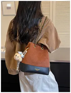 Women fashion quilted bucket shoulder bag with chain strap and cute bear pendant for autumn.