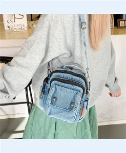 Casual denim crossbody bag detail view, showcasing multiple zippers and daily style.