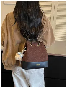 Stylish quilted bucket shoulder bag with chain strap and cute bear pendant for women.