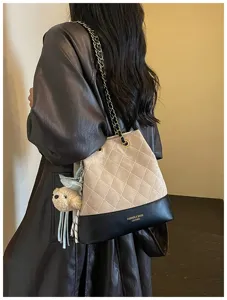 Stylish quilted bucket shoulder bag with chain strap and cute pendant for women daily commuting.