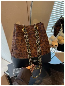Stylish leopard quilted bucket shoulder bag with woven chain straps for women commuting daily.