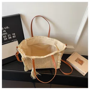 Woven straw beach tote bag for women with brown leather handles, shoulder straps and chic tassels.