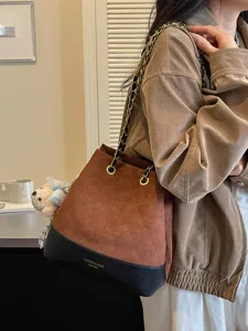 Stylish women autumn winter quilted bucket bag with chain strap and cute bear charm elegant.