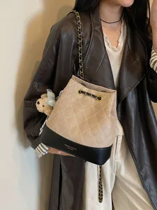 Chic quilted bucket bag with gold chain strap, elegant leather shoulder bag for women fashion.
