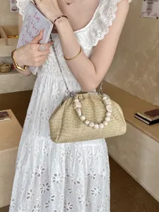 Sac bandoulière en paille tressée avec poignée de perles, pochette de plage élégante.
