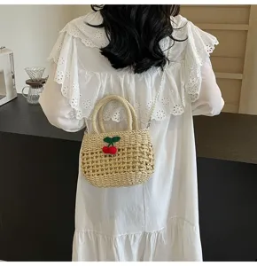 Pastoral style woven straw bag with cute cherry decor and pearl chain strap for summer beach.
