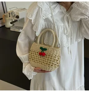 Straw woven handbag featuring a cute cherry decor and pearl strap for daily summer use.