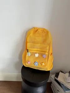 Yellow mesh beach backpack with cute crochet flowers, lightweight and breathable daily daypack.