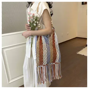 Boho style multi-color striped macrame shoulder bag with fringe, perfect for beach vacation.