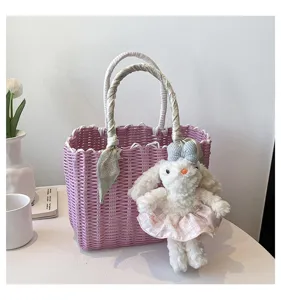 Korean style pink woven tote bag with cute plush rabbit pendant and stylish scarf handle detail.