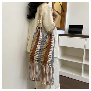 Bohemian fringe cotton woven shoulder bag with hollow fishnet design and wooden ring details.