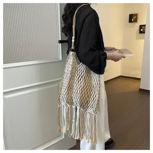 Boho fringe crochet shoulder bag detail view, stylish woven beach net bag for women.
