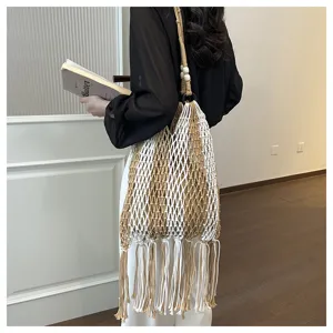 Boho tassel cotton woven shoulder bag detail, hollow net design, beach holiday style.