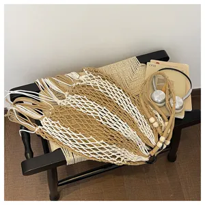 Handcrafted macrame woven bag detail showing intricate cotton cord knots and wooden beads.