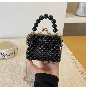 Mini black beaded crossbody bag with pearl handle, elegant kiss-lock evening handbag for women.