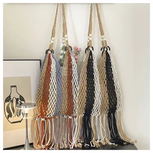Macrame fringe woven net shoulder bag detail view, bohemian beach handbag texture shot.