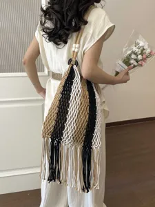 Bohemian fringe woven shoulder bag, hollow fishnet beach bag with chic tassels and rings.
