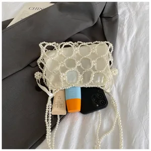 Close-up detail of the elegant white pearl beaded mini handbag, perfect for summer chic.