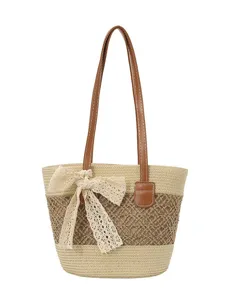 Women stylish straw woven tote bag with leather straps and cute lace bow for summer beach holiday.