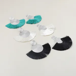 Exquisite fan-shaped tassel earrings with metal disc studs, bohemian style jewelry detail.